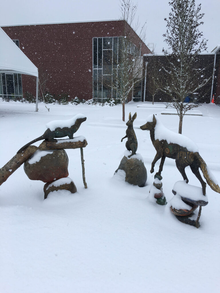 Snow falling on the Olympic Hills mascot, the otter, and his enclave, a few blocks from our Seattle home.