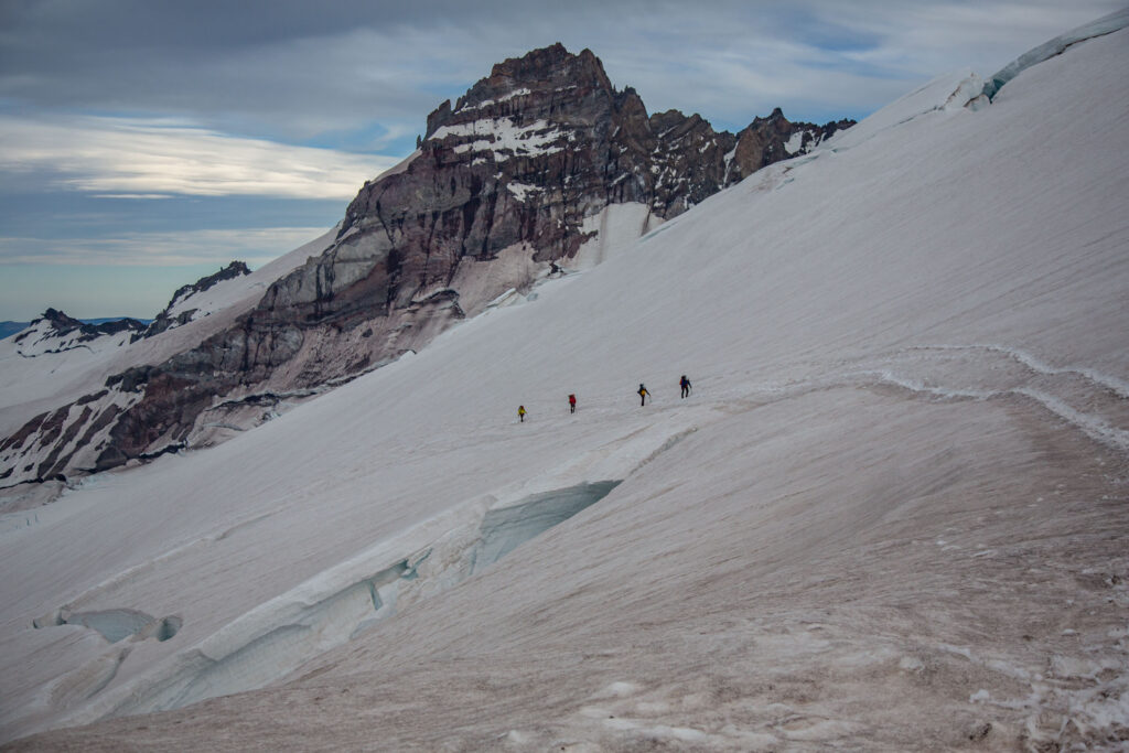 Little Tahoma behind a roped group of climbers on the approach into Camp Schurman, day 1. Note the size of crevasses in the foreground.