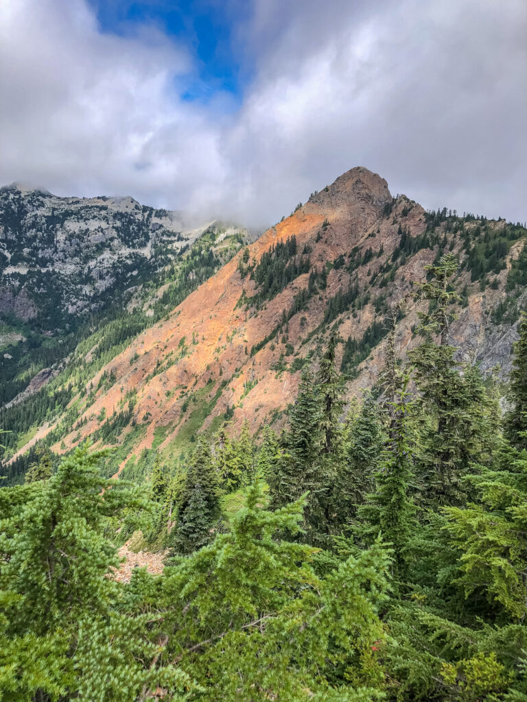 Even within a day, the same scenery can change. Here in the afternoon, Red Mountain gets illuminated by sunbeams poking through the dense clouds.