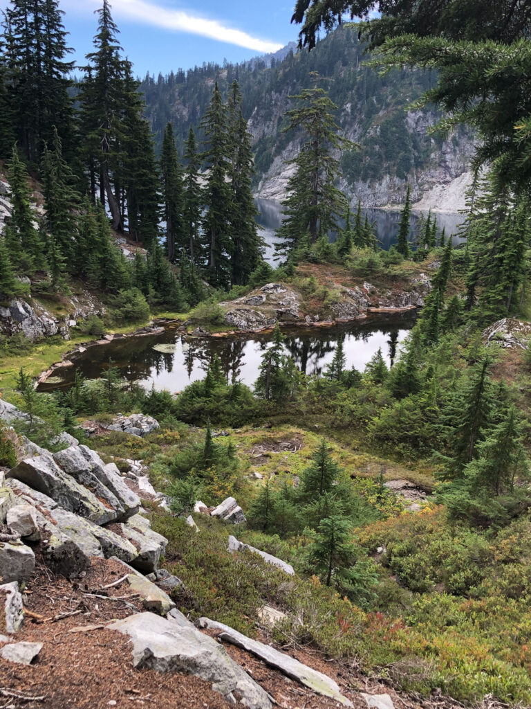 A tarn (foreground) with the larger Snow Lake behind it, on our way back from Gem Lake.