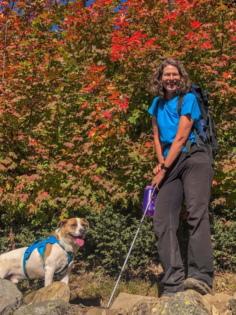 Smiles all around, in front of blazing red maple leaves.