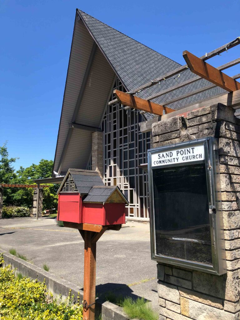 Sand Point Community Church boasts two neighborhood boxes, one for books and one for food. Both resemble the church.