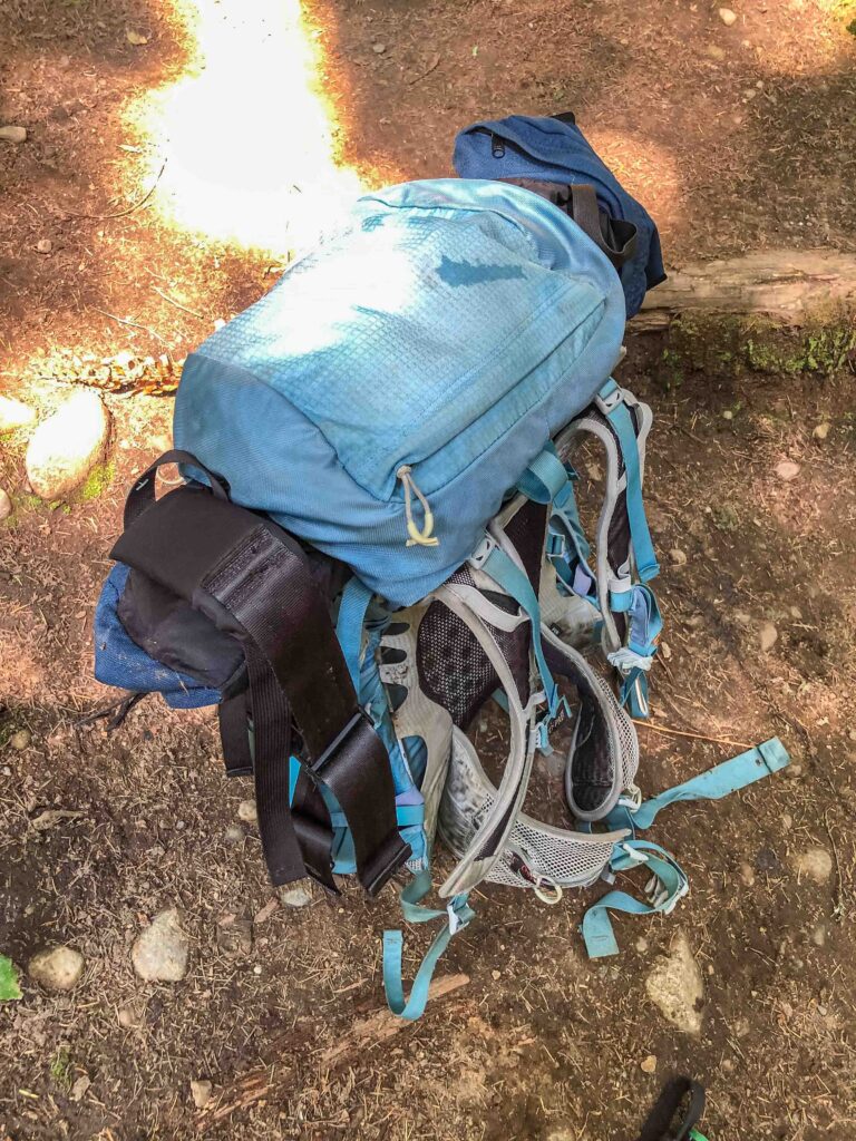On the ascent, I simply strapped her pack on my front like a Baby Bjorn front carrier. On the way down I got smart and unloaded her stuff into mine and folded up her pack. That way I could see my feet and reduce the risk of a fall.