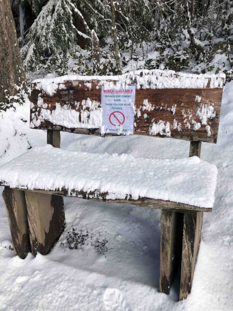 What a difference a week makes. On March 5, Squak had several inches of snow at the summit. This bench had a warning sign on it.