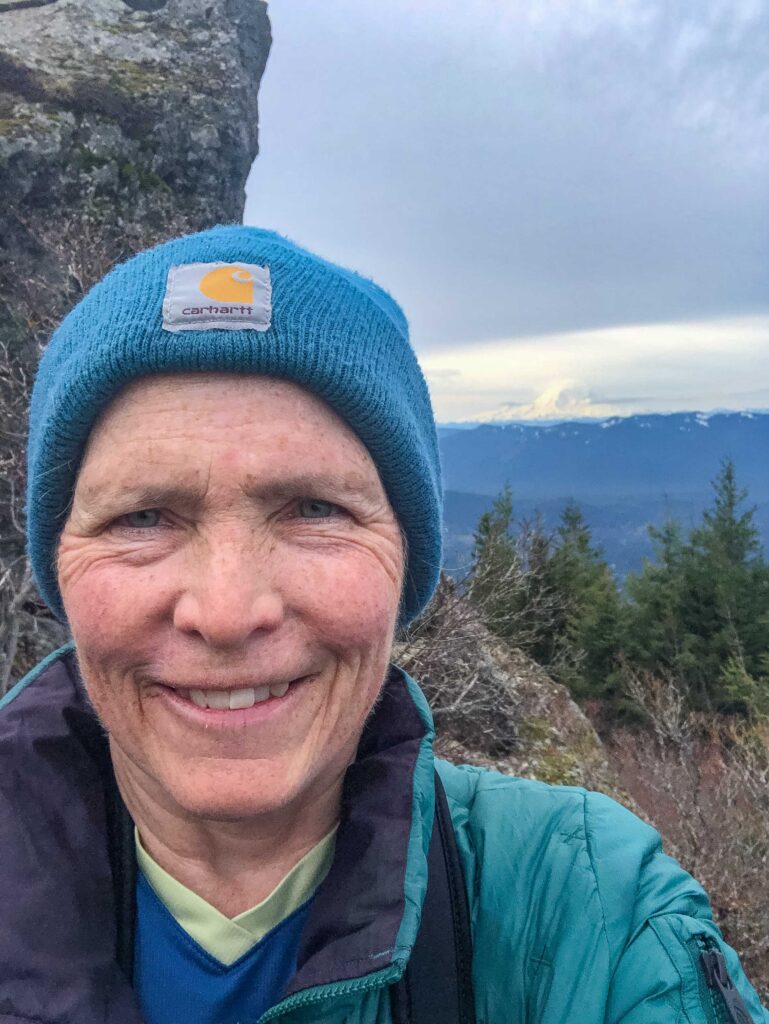 An author selfie with Mt. Rainier in the background, taken from the summit area on Mt. Si.