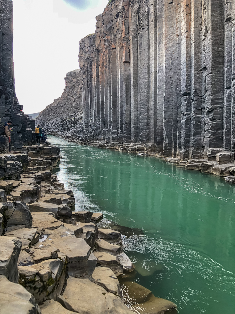 Over many years, this fault-strewn valley has been carved by powerful water, leaving vertical basalt columns intact.